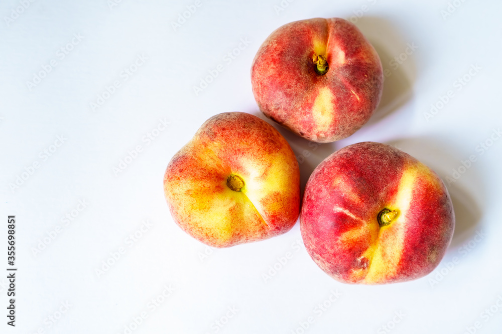 Sweet orange ripe fig peaches on the white background witch copy space Sweet orange ripe fig peaches on the white background witch copy space