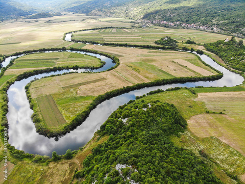 Fotografie Aerial view of river Lika meandering through Donji Kosinj and Lipovo Polje villages in Croatia