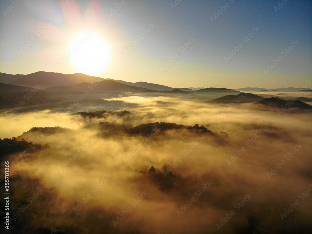 Fototapeta premium Aerial view of foggy sunrise in Donji Kosinj, Croatia