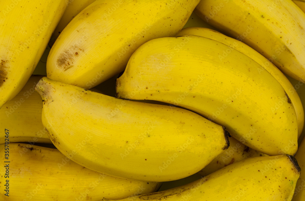 Many ripe yellow bananas close up
