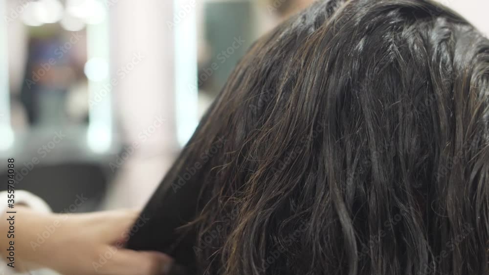 Hairdresser drying woman hair with hair dryer slow motion Hairdresser drying woman hair with hair dryer slow motion