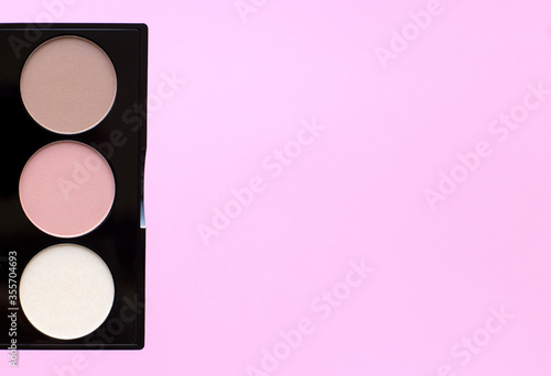Healthy vegan decorative cosmetic for make up close up on pink background. Eye shadow, highlighter, blush. Conscious consumption.