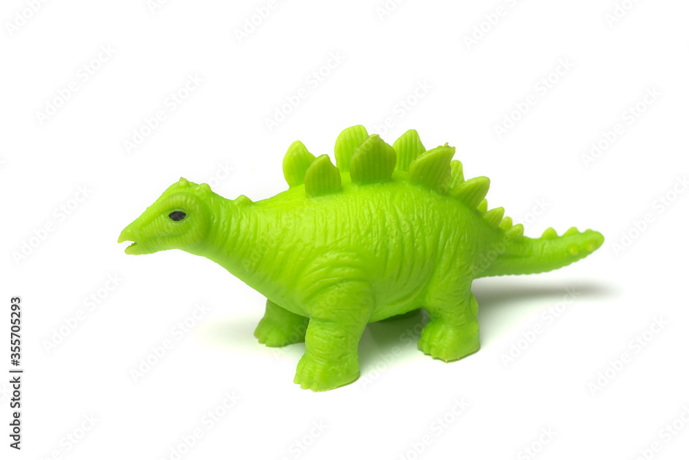 Closeup of green plastic dinosaur toy on white background