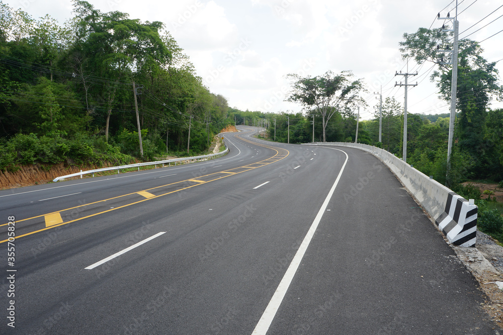 empty asphalt road in countryside of Nan Province, Thailand