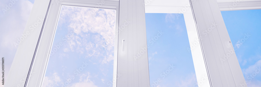 Large white plastic window with blue sky panoramic