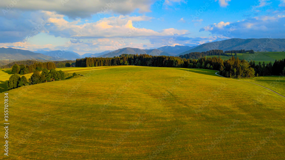 Obraz premium Flight over the beautiful rural landscape of Bavaria Allgau in the German Alps. Aerial view