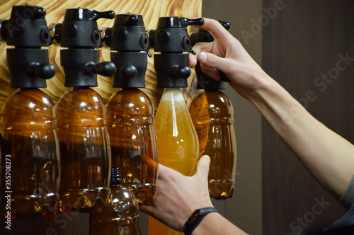 bartender pouring beer into bottle photo