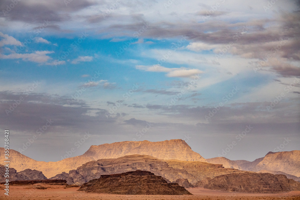 Naklejka premium Red sand and rocks in the Wadi Rum desert in Jordan.