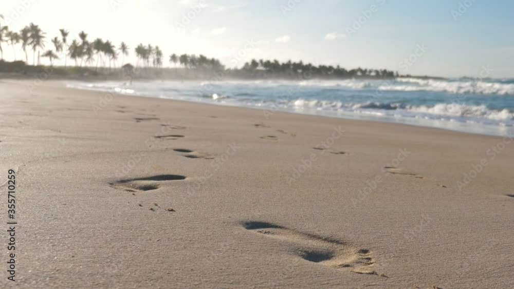 Sunset on macao beach with waves on the sea. Footprints on sand. Summer vacations. Travel destinations Sunset on macao beach with waves on the sea. Footprints on sand. Summer vacations. Travel destinations