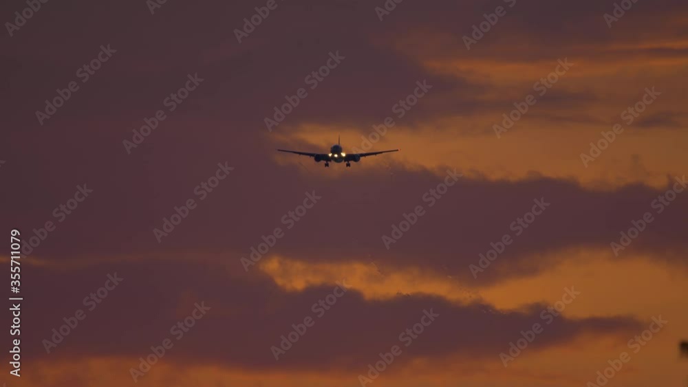 Airplane approaching over ocean at sunset backgfround Airplane approaching over ocean at sunset backgfround
