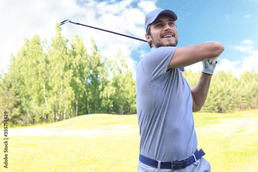 Golfer hits an fairway shot towards the club house. Golfer hits an fairway shot towards the club house.
