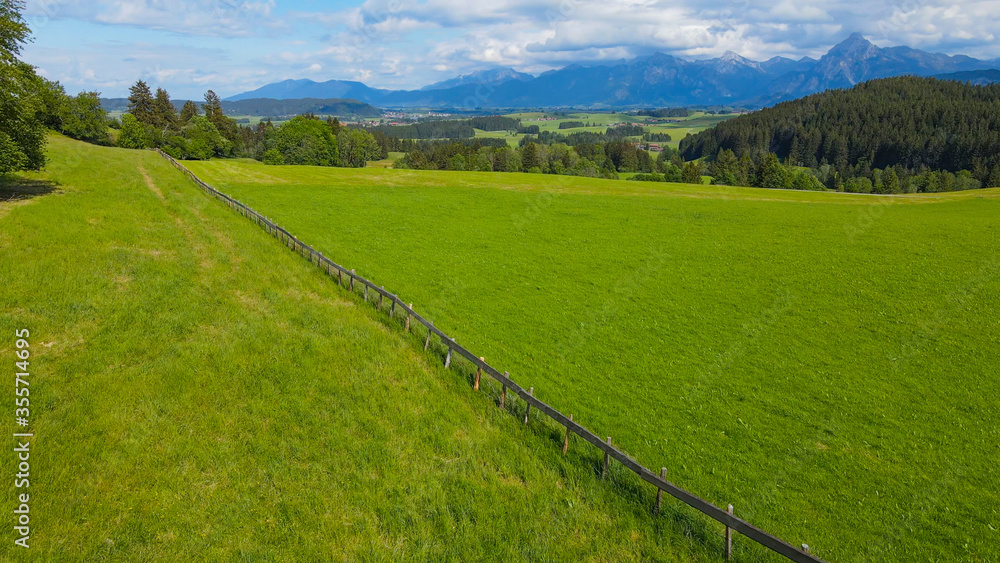 Flight over the beautiful rural landscape of Bavaria Allgau in the German Alps. Aerial view