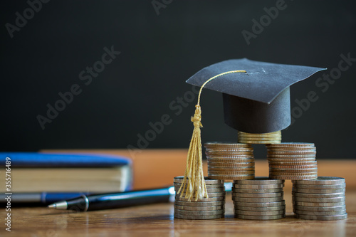 hat graduation model on money coins saving for concept investment education and scholarship photo
