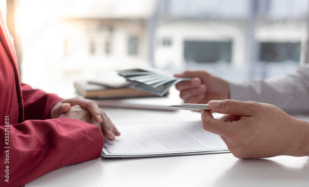 Businessmen give dollars to bribe employees in signing contracts to buy illegal land and real estate, Business fraud and social injustice, corruption and bribery concept. Businessmen give dollars to bribe employees in signing contracts to buy illegal land and real estate, Business fraud and social injustice, corruption and bribery concept.