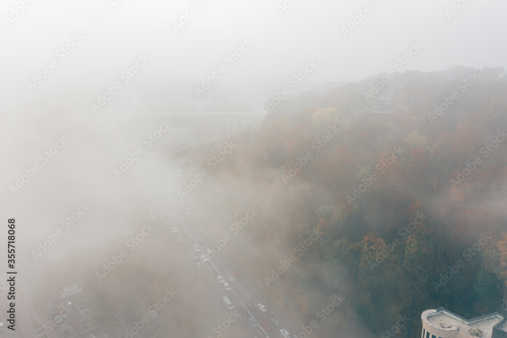 A city covered in fog. City traffic, aerial view