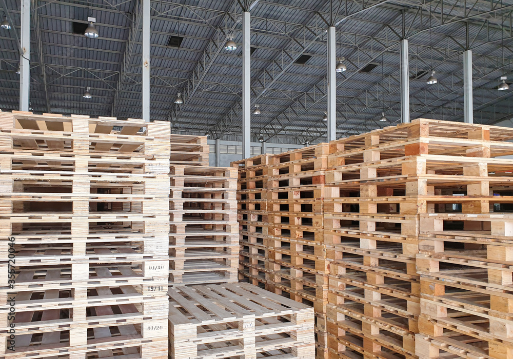 Wooden pallets stacked in stock at warehouse storage. Wooden pallets stacked in stock at warehouse storage.