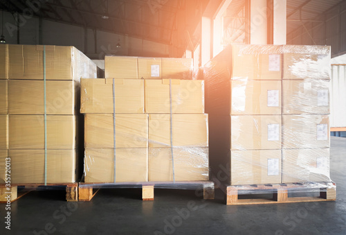 Stack of shipment boxes on wooden pallets. Interior warehouse storage. Cargo export. Warehouse industry shipping logisics.