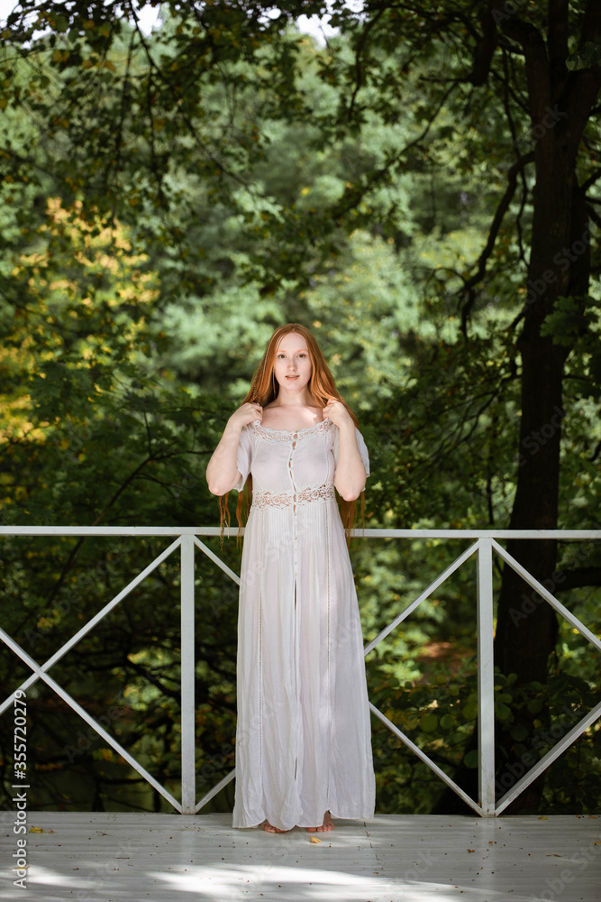 red-haired long-haired girl with freckles in nature red-haired long-haired girl with freckles in nature