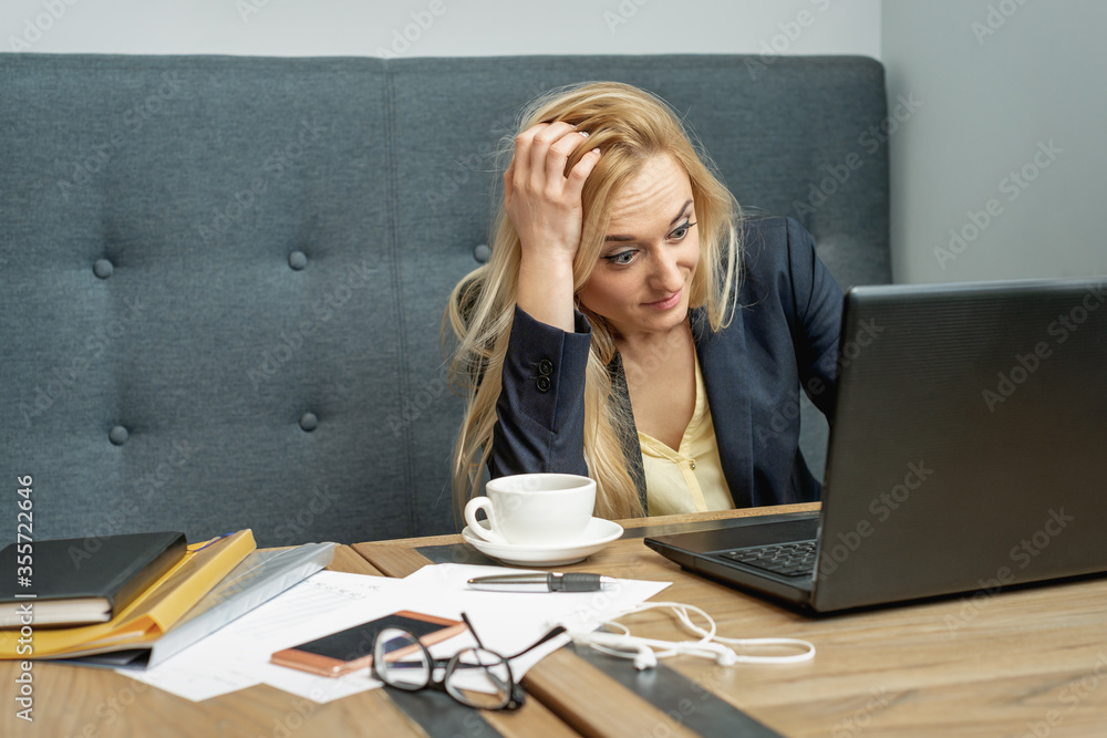 Woman looking surprised while using the laptop at the workplace at home. Woman looking surprised while using the laptop at the workplace at home.