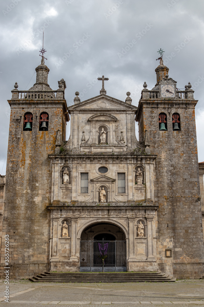 Frontal view of the Cathedral of Viseu, at Easter time, with a cross hanging at the entrance