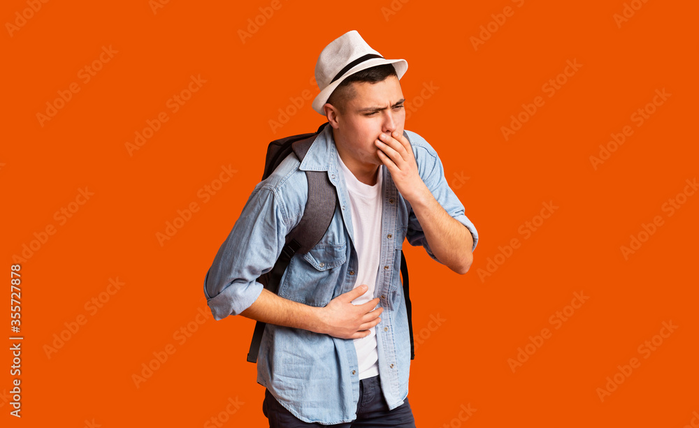 Young male tourist having troubles with digestive Young male tourist having troubles with digestive