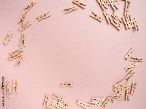 Wooden clip isolated on pink background.