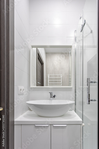 Modern bathroom with white tiles  sink and mirror 0075