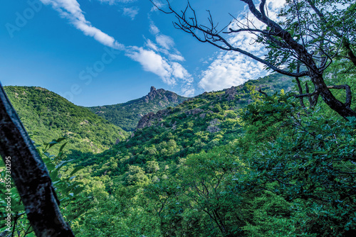 Green rolling hills revealing a rocky mountain summit near the town of Sliven in Bulgaria. 