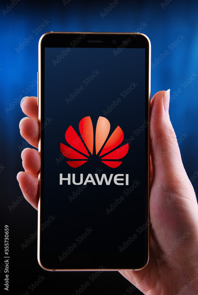 Hands holding smartphone displaying logo of Huawei Photos | Adobe Stock