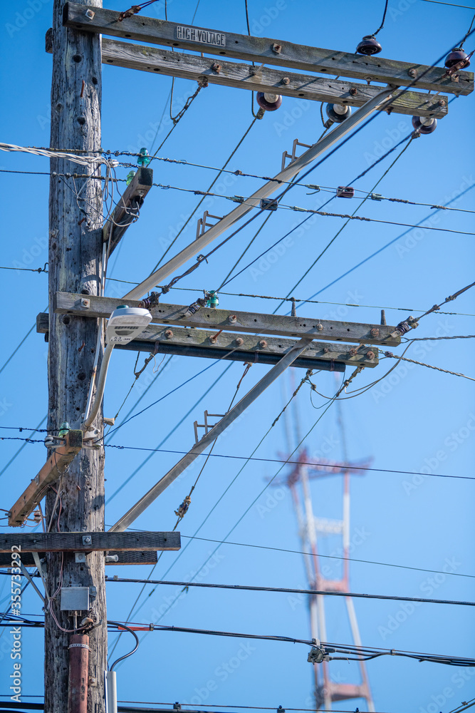 Power pole and wires in San Francisco's Cole Valley neighborhood. Sutro Tower on Twin Peaks visible in the distance. Power pole and wires in San Francisco's Cole Valley neighborhood. Sutro Tower on Twin Peaks visible in the distance.