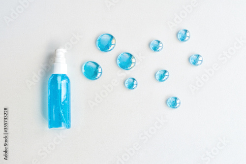 Blue gel spray, drops, glass, on a white background, top view.
