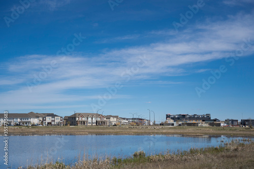 Calgary, Alberta, Canada, June 01 2020: An subdivision developed up to designated habitat at the City Scape Wetlands.