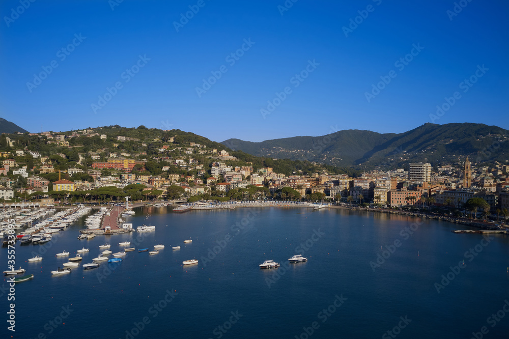 Panoramic aerial view of the bay of the tourist city of Rapallo, Genoa, Italy. Boat parking, resorts in Italy. Aerial photography with drone.