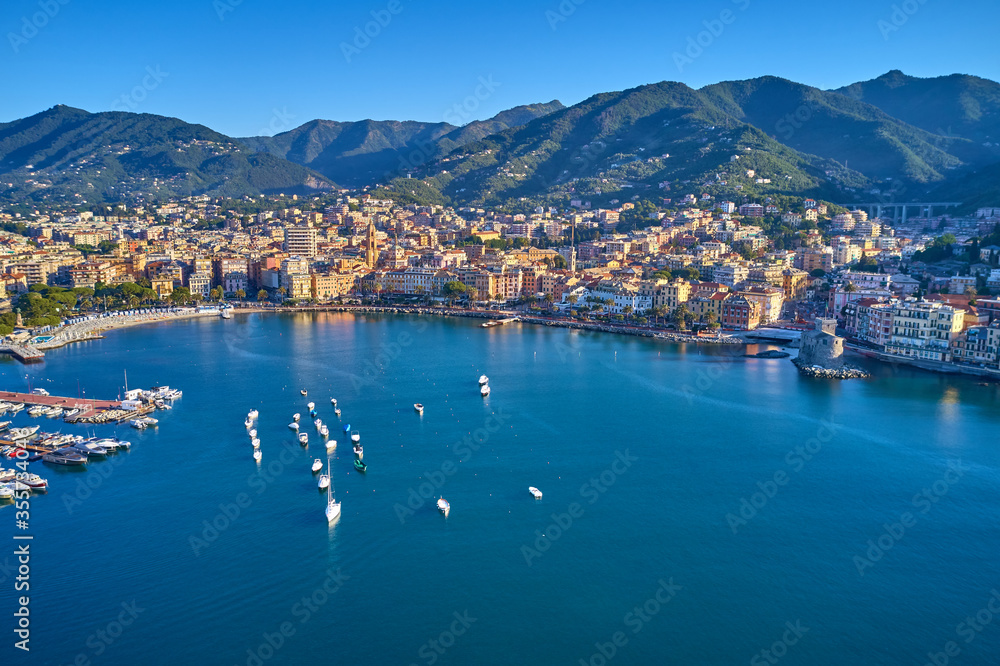 Obraz premium Panoramic aerial view of the bay of the tourist city of Rapallo, Genoa, Italy. Boat parking, resorts in Italy. Aerial photography with drone.