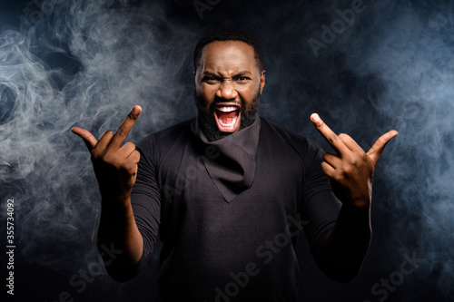 Фотография Photo of aggressive angry afro american guy show fucking symbol ignore racists s
