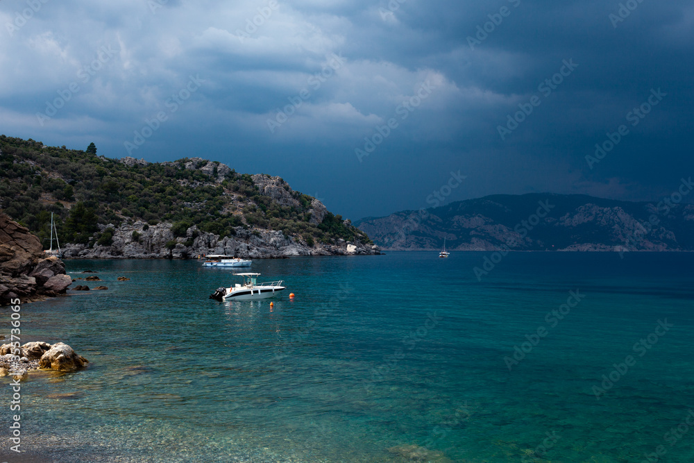 Fototapeta premium A body of water with boat and mountains in the background