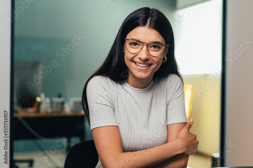 Cheerful beautiful caucasian girl student professional standing at home in office looking at camera, happy confident entrepreneur  laughing face posing alone, head shot close up view portrait. Webcam
