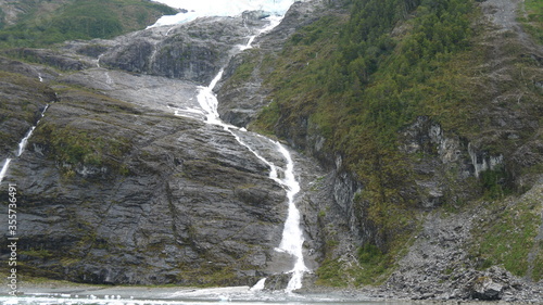 Aesthetic photography of the waterfalls that descend from the Argentine Andes mountains due to the melting near the famous Argentine glacier, the perito moreno