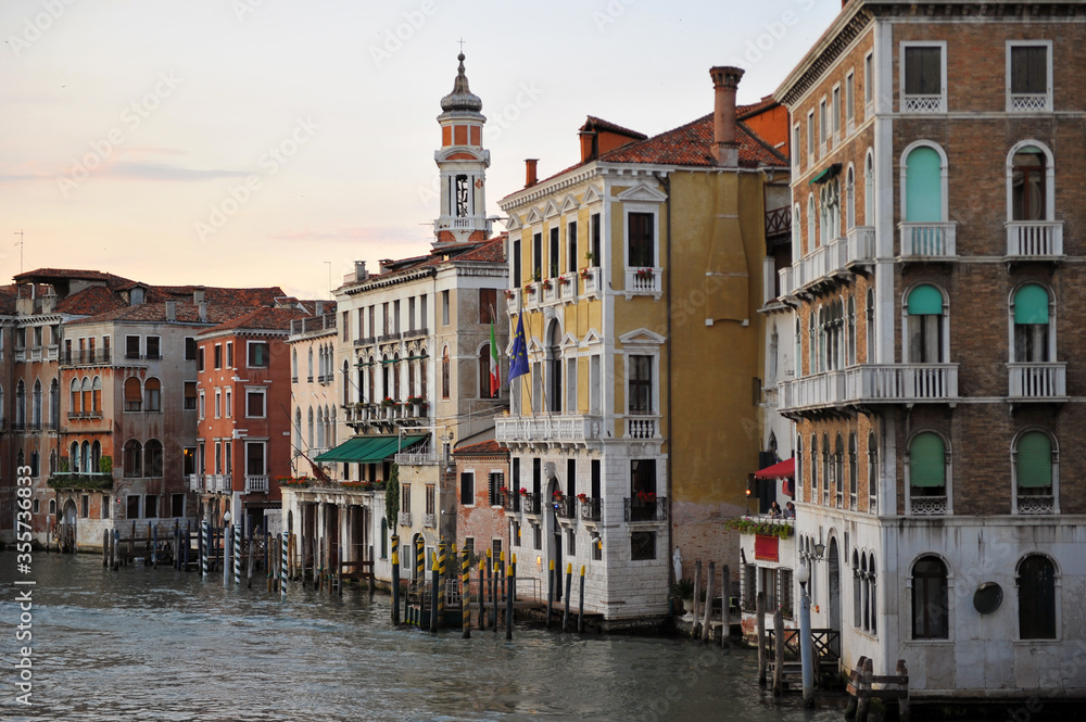 Venice channels with boats, gondolas, and colorful houses and towers