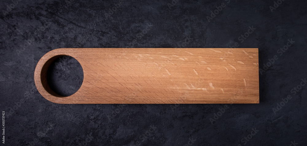 Food background. Copy space. Cutting board on black table. Wood.