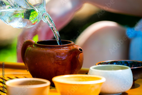Tea ceremony. Teapot and bowls with Chinese tea on a wooden table