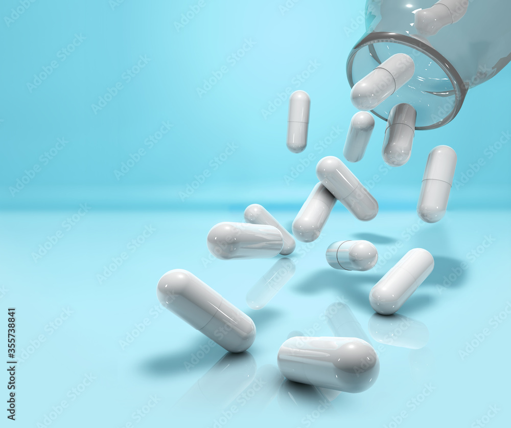 capsules falling from glass bottle on blue background capsules falling from glass bottle on blue background