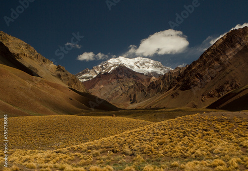 Mountaineering. Andes Landscape. View of the Aconcagua mountain, highest peak in America, and the golden meadow and valley in autumn