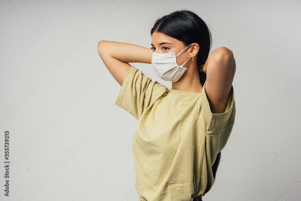 Beautiful confident young Caucasian girl with surgical mask . Covid-19 coronavirus. Professional student girl close up front portrait. Isolate 
