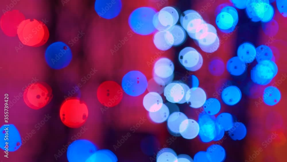 Flashing colored lights in a blur. The bokeh effect. Abstract Disco lights on the backdrop. Club concert dance disco dj matrix beam dmx fashion.Electric Christmas tree lights on red background Flashing colored lights in a blur. The bokeh effect. Abstract Disco lights on the backdrop. Club concert dance disco dj matrix beam dmx fashion.Electric Christmas tree lights on red background