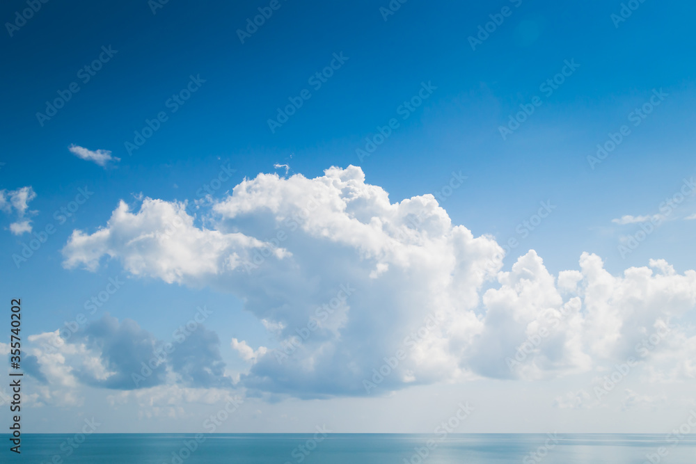 White fluffy clouds and turquoise sea on blue sky White fluffy clouds and turquoise sea on blue sky