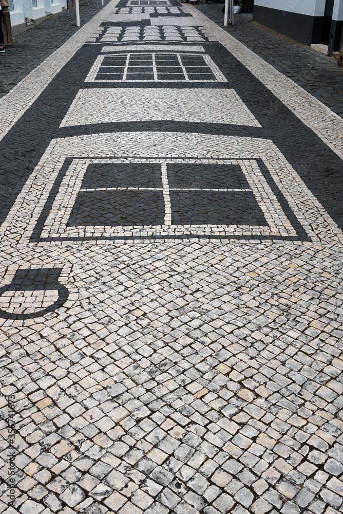 Fototapeta premium the street of praia da vitoria. details of the paved street in praia da vitoria, azores, portugal