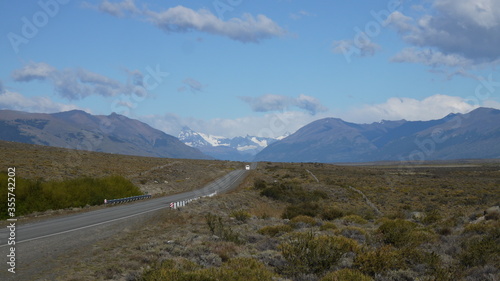 aesthetic photography of a road between the green mountains of the Andes and in the background the snowy mountains
