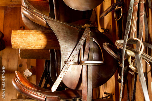 Photos close up of brown Saddles in a Tack Room