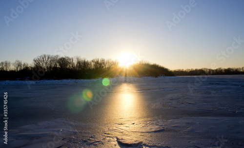 Beautiful winter sunset on the background of the river